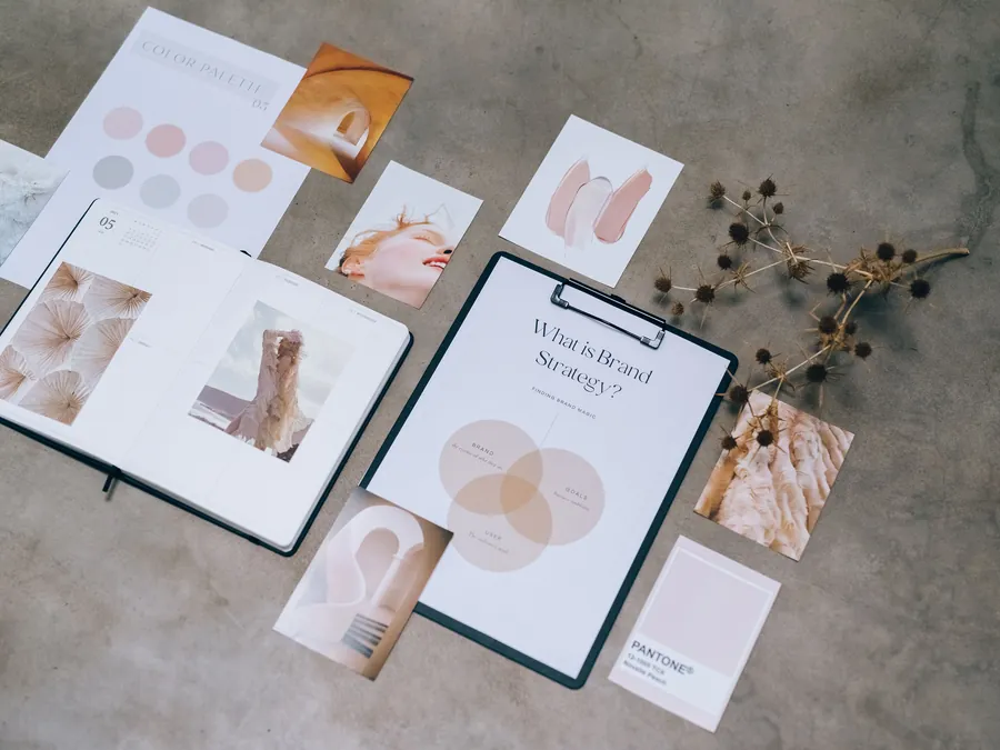 Brand strategy materials, colour palette and moodboard on a desk