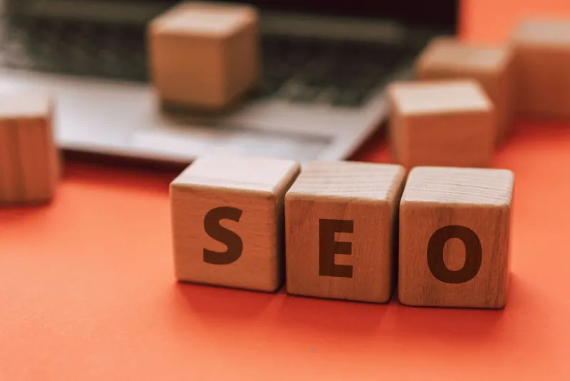 SEO wooden blocks in front of a laptop