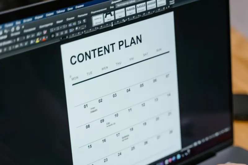 Laptop showing a content plan document for social media scheduling